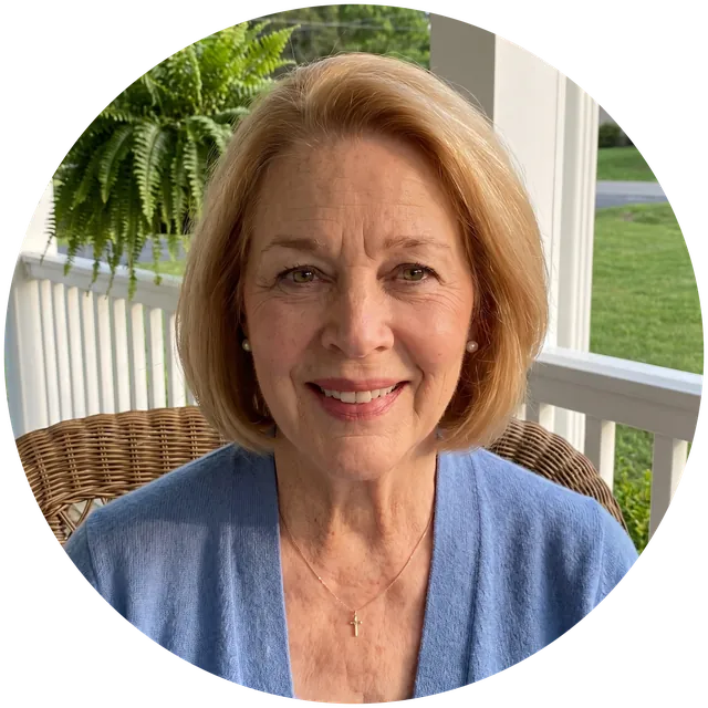 A portrait of Loretta, an AI character: a smiling woman with a honey-blonde bob and a blue cardigan, sitting on a porch.